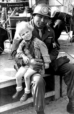 US Army MP holds young German girl following end of hostilities and beginning of Allied occupation of Germany Munich Bavaria Germany Oct45.jpg